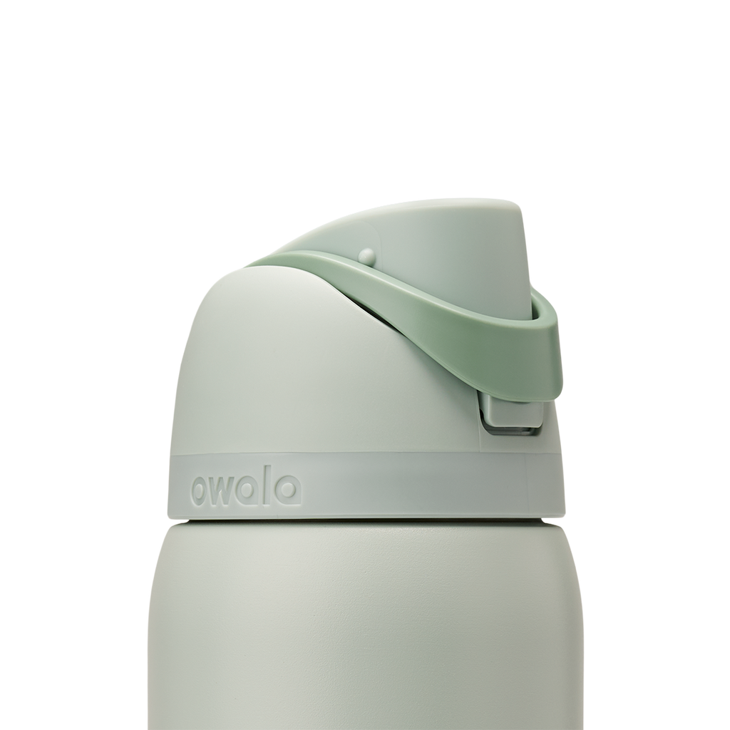 Owala FreeSip 32oz in Summer Paradise, lid detail showing sage green flip cap closed with mint green carry loop arched over the top and embossed accent band at the lid base